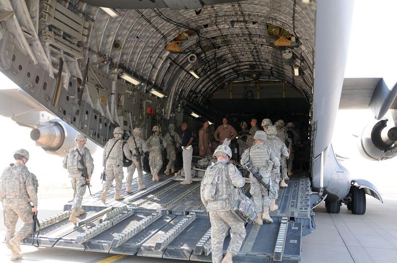 The flight crew of a C-17 oversees the boarding of soldiers from 3rd Infantry Division at Contingency Operating Base Speicher, Iraq, Aug. 23.
